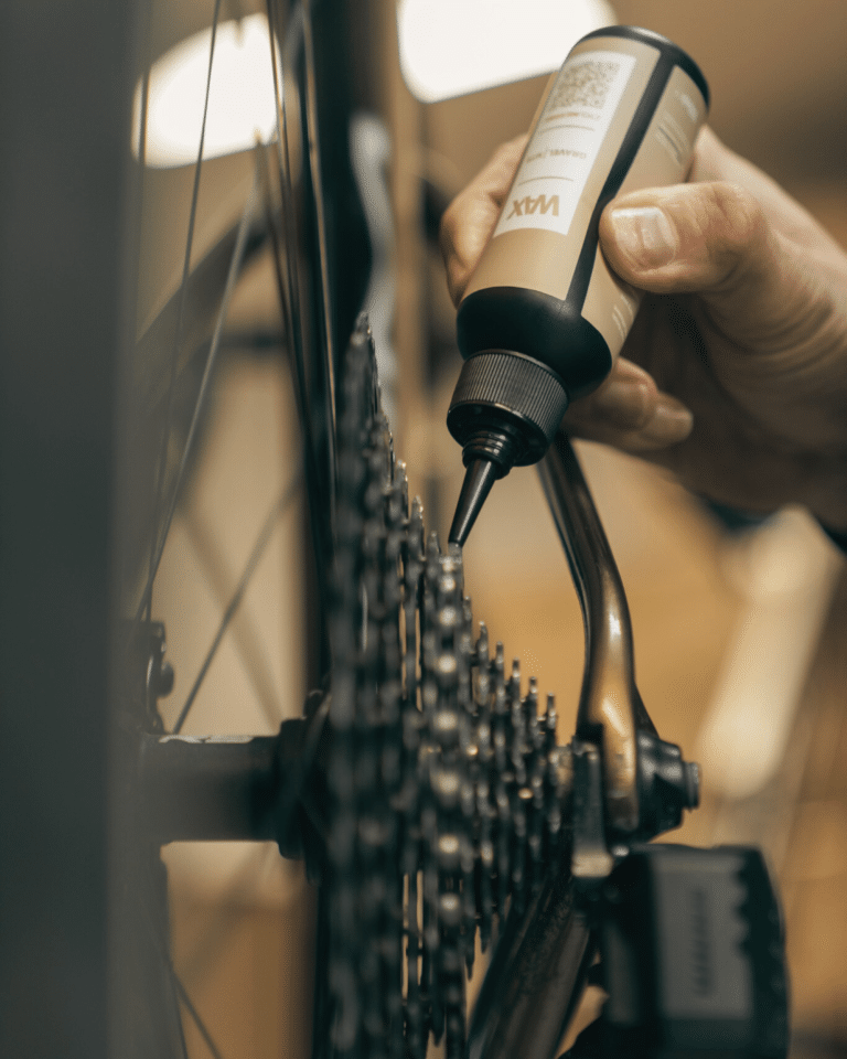 Application of drivetrain wax lubricant on a bicycle cassette using a precision bottle